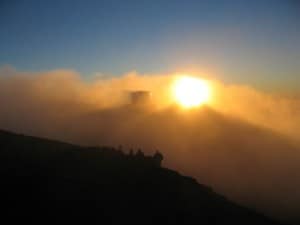 The sun glows through clouds at Haleakala National Park.